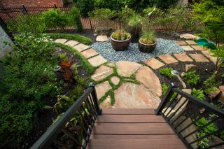 Lush garden with stone pathway and pots