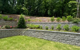 Lush garden with stone walls.