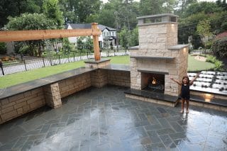 Outdoor patio with fireplace and child