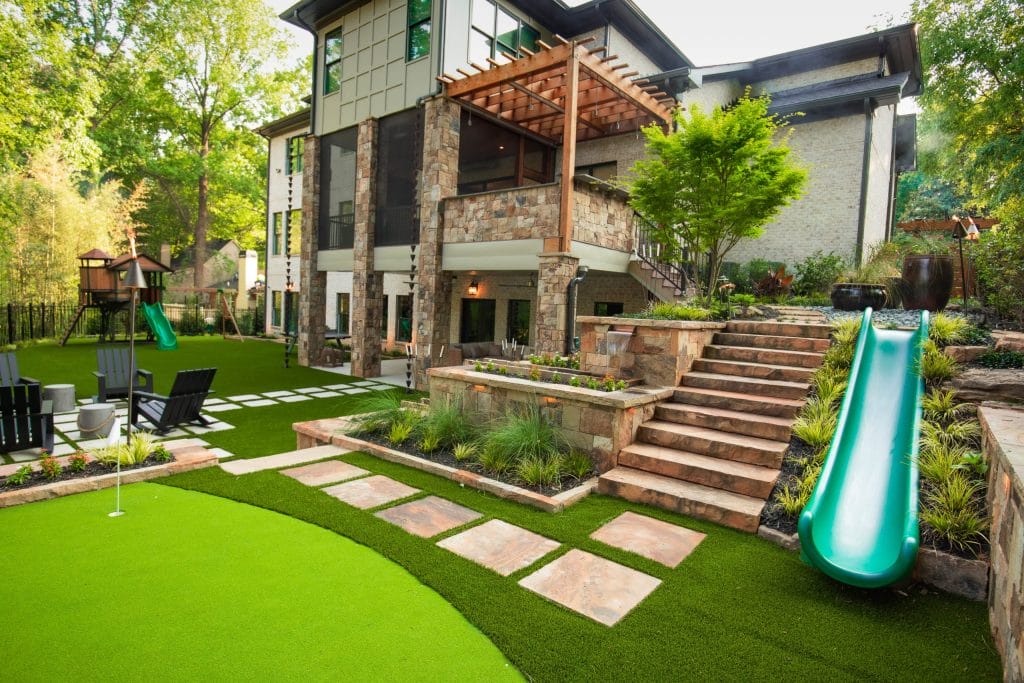 Modern backyard with slide and greenery