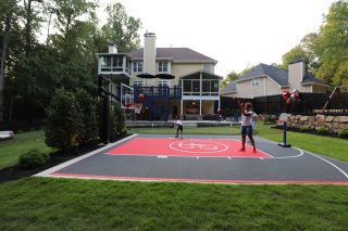 Children playing basketball in backyard