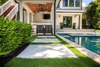 Modern backyard with pool and patio.